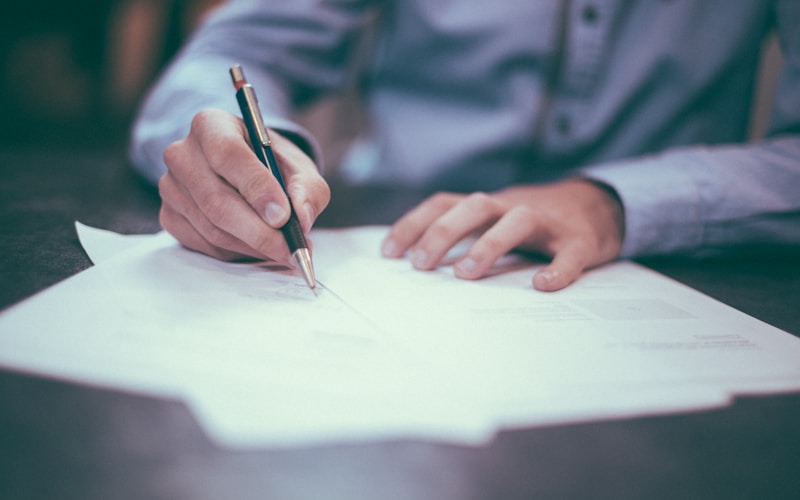 Reviewing loan documents and lending options at a desk